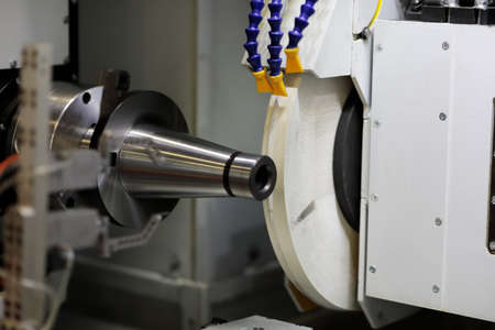 Workpiece processing with an abrasive wheel on circular grinding machine. Selective focus.
