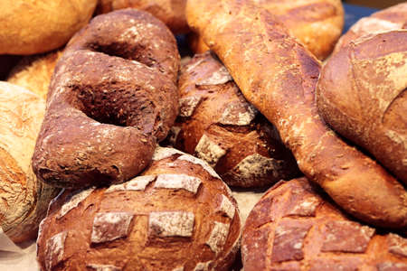 Varied bread loaves on a bakery shop counter. Selective focus.