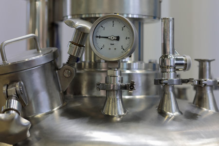 Stainless steel chemical reactor with pressure gauge. Selective focus.の写真素材