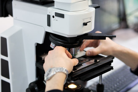 Scientist working with optical microscope in laboratory. Selective focus.