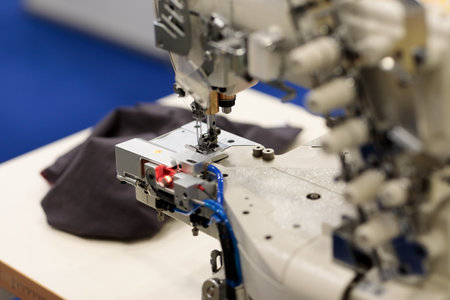 Close up of coverstitch industrial sewing machine. Selective focus.