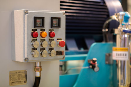 Industrial manufacturing machine with control box on the foreground. Selective focus.