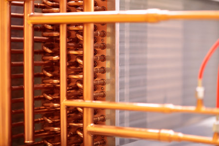 Close up of heat exchanger with copper pipes. Industrial air conditioning HVAC system. Selective...