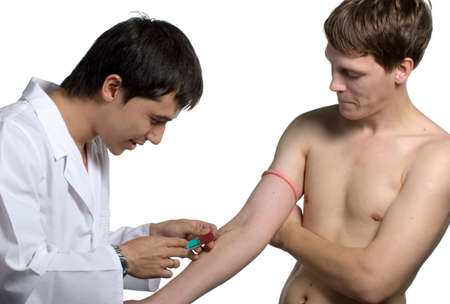 The doctor does an injection in a vein in a clinic.の写真素材