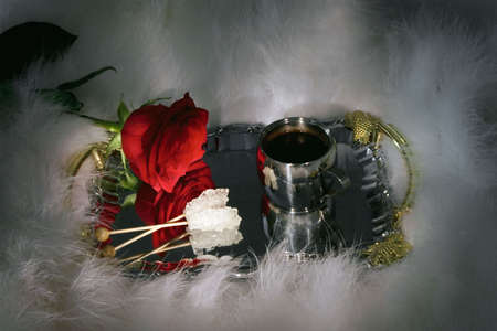 Romantic still-life with cup of coffee and red rose on a metal tray.の写真素材