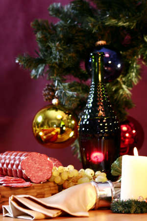 Wine, grapes and sausage on a New Year's background.の写真素材