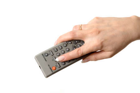 Female hand pressing an  button on the TV remote control. Isolated on white.