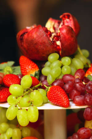 Assorted fresh fruit including grapes, strawberry and pomegranateの写真素材