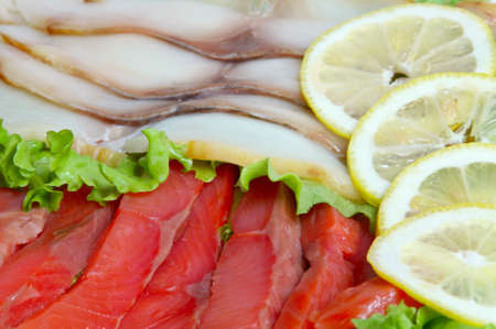 Cutting trout and mackerel with lemon. Close upの写真素材
