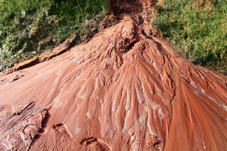 Wet red sand.  Water has etched a pattern into sand. Ham Tien canyon in Vietnamの写真素材