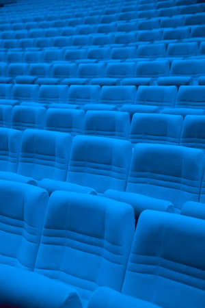 Rows of blue arm-chairs in empty auditoriumの写真素材
