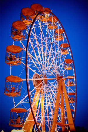 Fairy ferris wheel  at amusement park in twilightの写真素材