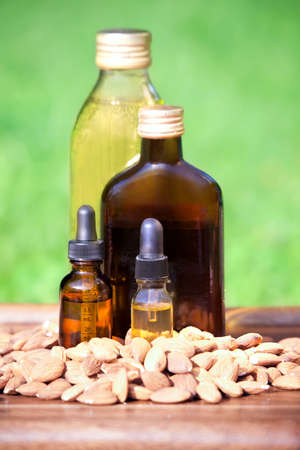 Almond oil in a bottles and almonds nuts. The concept of use of natural almond oil  in cosmetology and dietary foodの写真素材