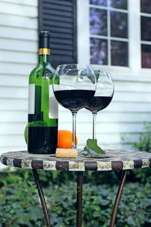 Bottle of Wine and glasses on a garden table
