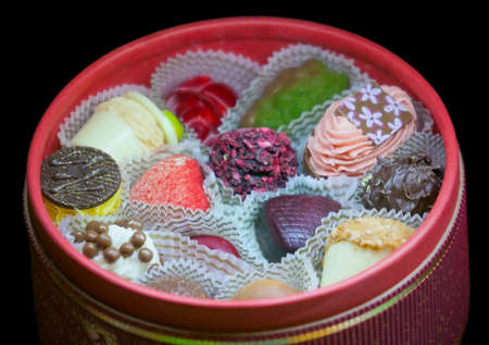 Handmade chocolates in a round boxの写真素材