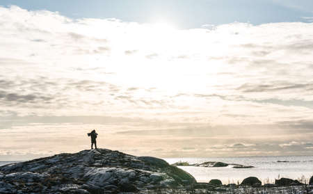 Girl outdoor watching the ocean in Norwayの写真素材