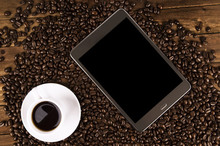Morning coffee cup with a digital tablet for business workの写真素材