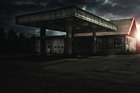 Abandoned freaking old gas station, sunset in background.の写真素材