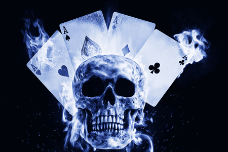 Skull and playing cards in fire on a black background. Photo manipulation artwork, 3D rendering.の写真素材