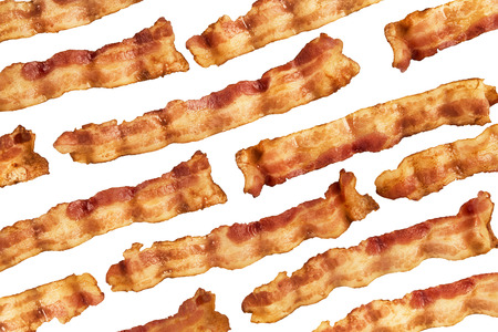 Background of bacon slices disposed in diagonal and isolated on white background. Directly above.の写真素材