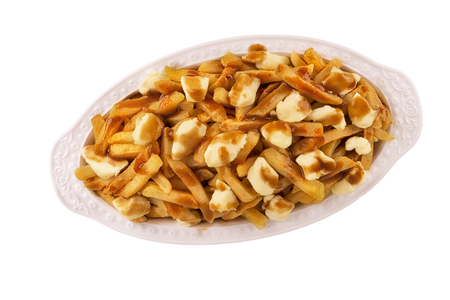 Poutine plate isolated on white background, top view. Cooked with french fries, beef gravy and curd cheese. Canadian cuisine.の写真素材