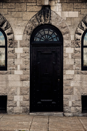 Old style black iron entrance door. Front view.