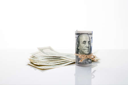 Banknote one hundred dollars, tied with rope, and US dollarsの写真素材