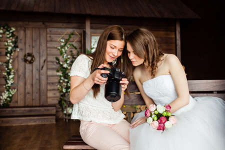Young sexy photographer shows the bride had just taken photosの写真素材