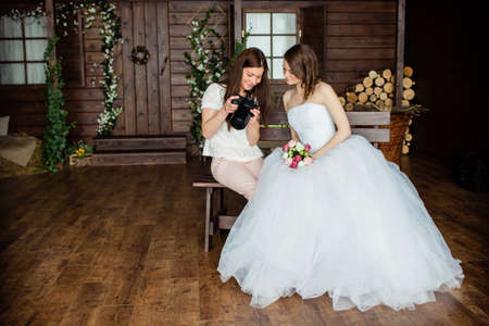 Young sexy photographer shows the bride had just taken photosの写真素材