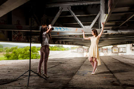 Young sexy model posing to photographer under the bridgeの写真素材