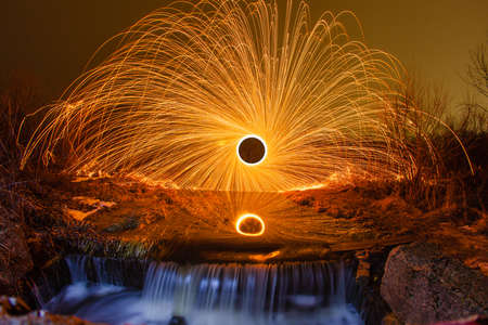 Sparks from the burning steel wool and waterfall