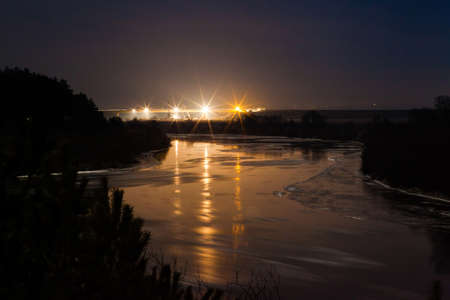 Floating on the river ice in moonlit winter nightの写真素材