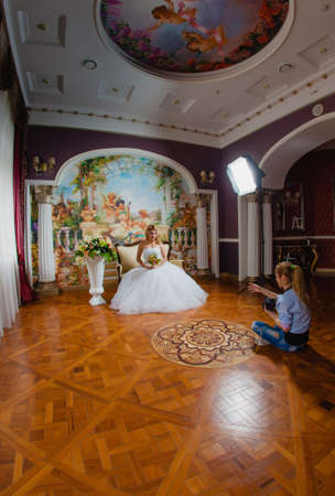 Wedding photographer is taking pictures the bride in the studiの写真素材