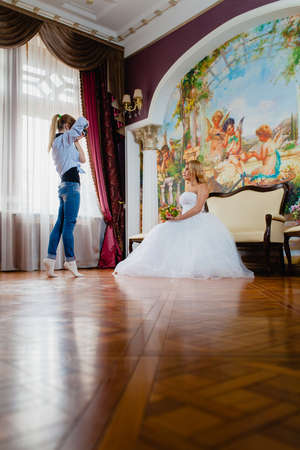 Wedding photographer is taking pictures the bride in the studiの写真素材