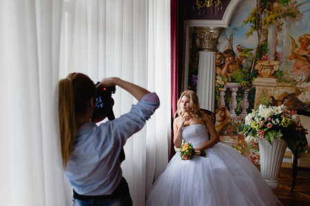 Wedding photographer is shooting portrait of the bride in the studioの写真素材