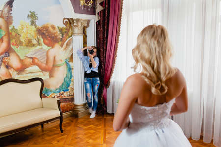 Wedding photographer is taking pictures the bride in the studiの写真素材