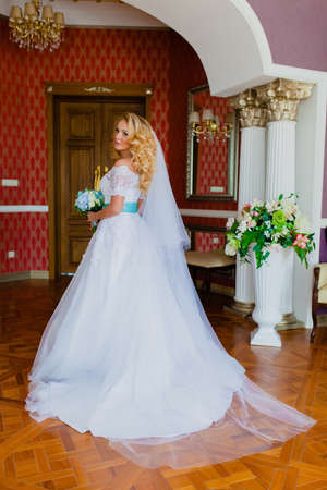 Portrait of a young beautiful bride in a beautiful classic interiorの写真素材