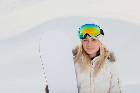 Portrait of young sexy woman with her snowboardの写真素材