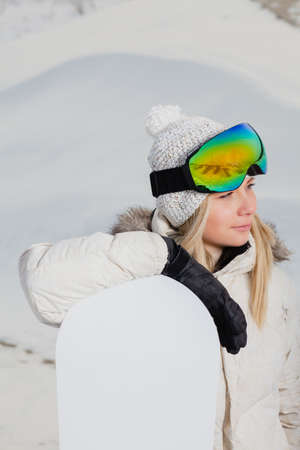 Portrait of young woman with her snowboardの写真素材