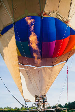 Colorful hot air balloon in blue sky at sunsetの写真素材
