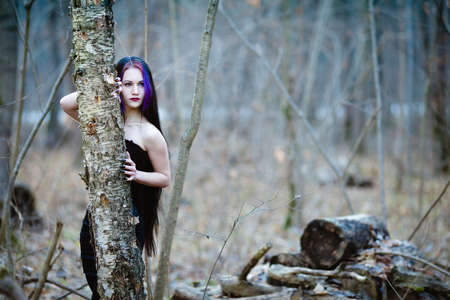 Portrait of the gothic woman in the dark winter forestの写真素材