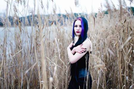 Portrait of the gothic woman in a high, dry grassの写真素材