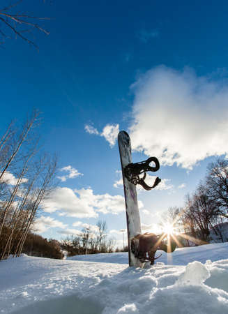 Ski slope, snowboard and blue skyの写真素材