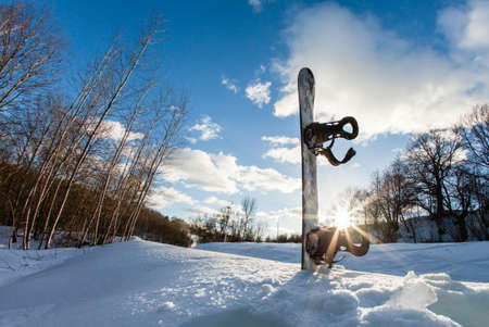 Ski slope, snowboard and blue skyの写真素材
