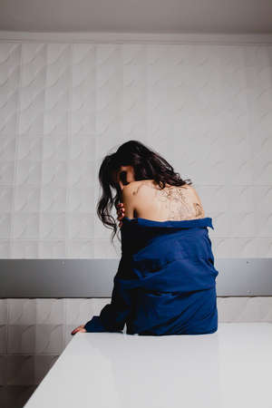 Slender brunette with henna ornaments drawn on her backの写真素材