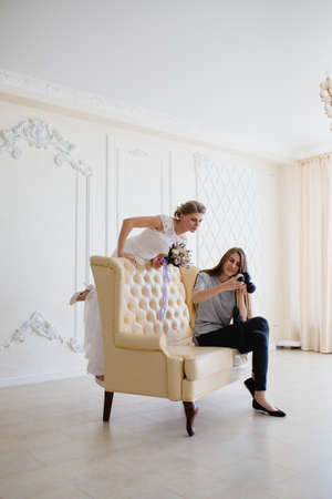 Photographer with long hair shows the bride had just taken photosの写真素材