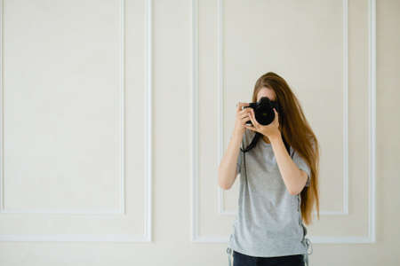 Woman photographer taking a shoot in a studioの写真素材