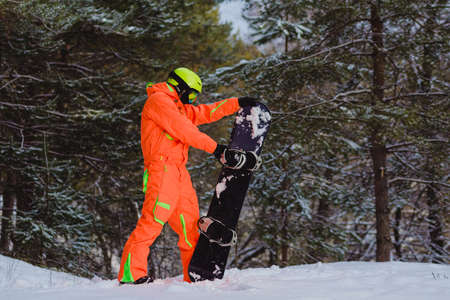 Snowboarder checks his equipmentの写真素材
