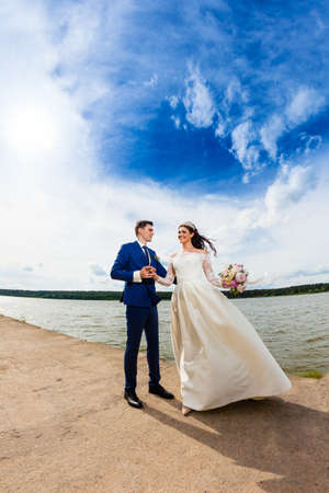 Beautiful couple newlyweds near the lakeの写真素材