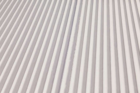 Texture of new groomed snow on empty ski slope